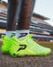 Phenom Elite Rick and Morty cleat lifestyle photo — athlete in action wearing cleats