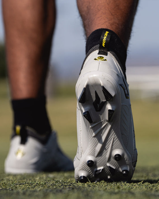 Phenom Elite Warhawk cleat lifestyle photo — athlete in action wearing Quantum Speed 2.0 cleats