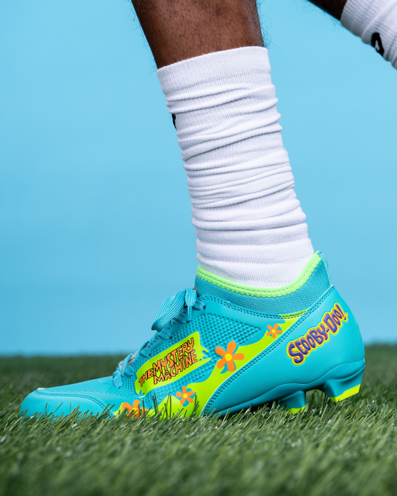 Phenom Elite Scooby-Doo cleat lifestyle photo — athlete wearing Mystery Machine cleats