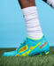 Phenom Elite Scooby-Doo cleat lifestyle photo — athlete wearing Mystery Machine cleats